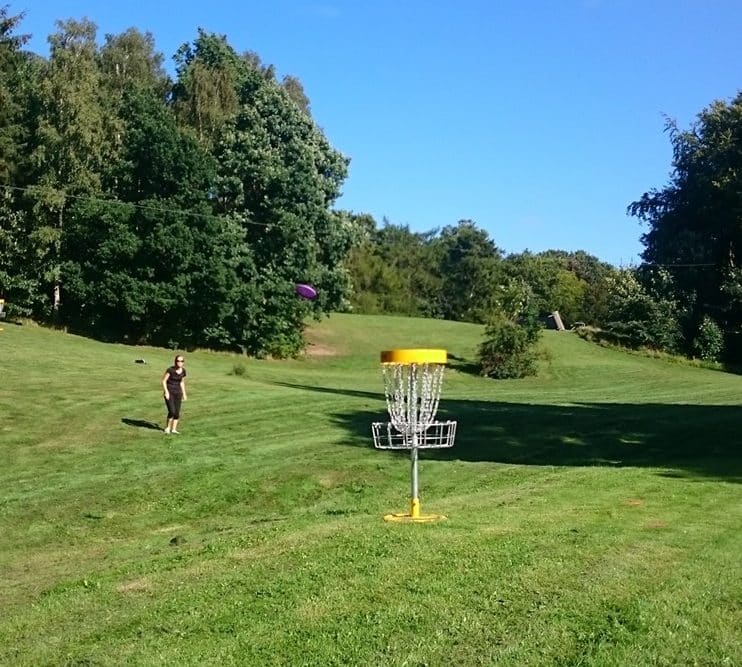Tag en kollega, en ven eller familien i hånden og spil Disc Golf I Havreholm Klatrepark